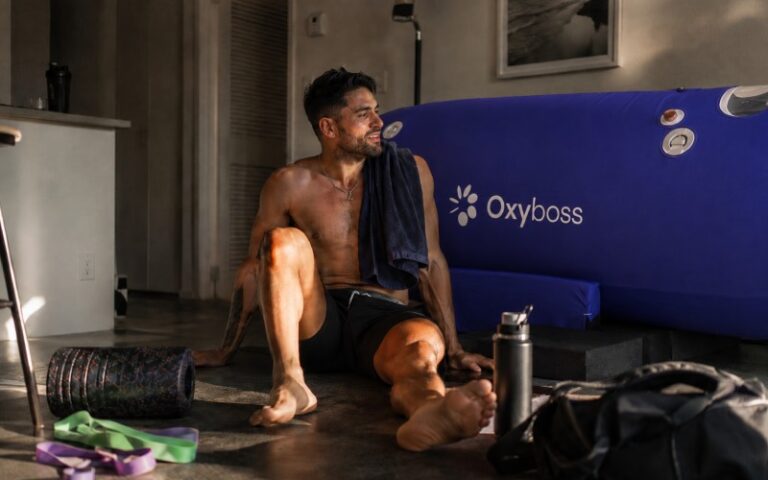 Athlete recovering beside a hyperbaric chamber