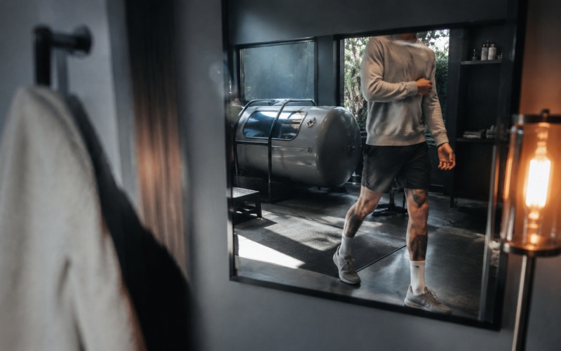 Athlete reflected inside a recovery studio