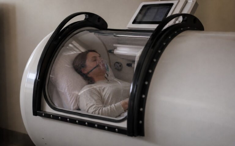 Person resting inside a hyperbaric chamber