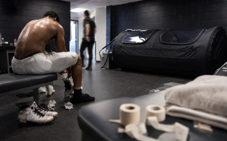 Player recovering beside a hyperbaric chamber after a football game