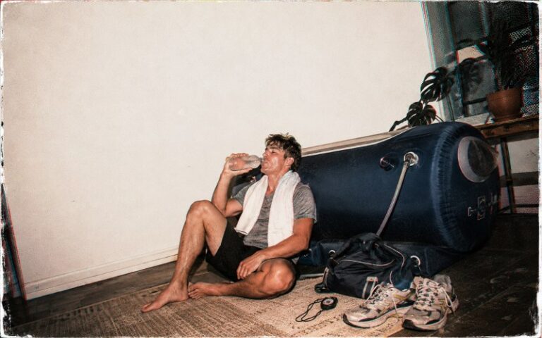 Post-workout athlete beside a hyperbaric chamber