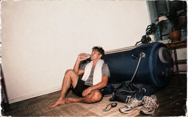 Post-workout athlete beside a hyperbaric chamber